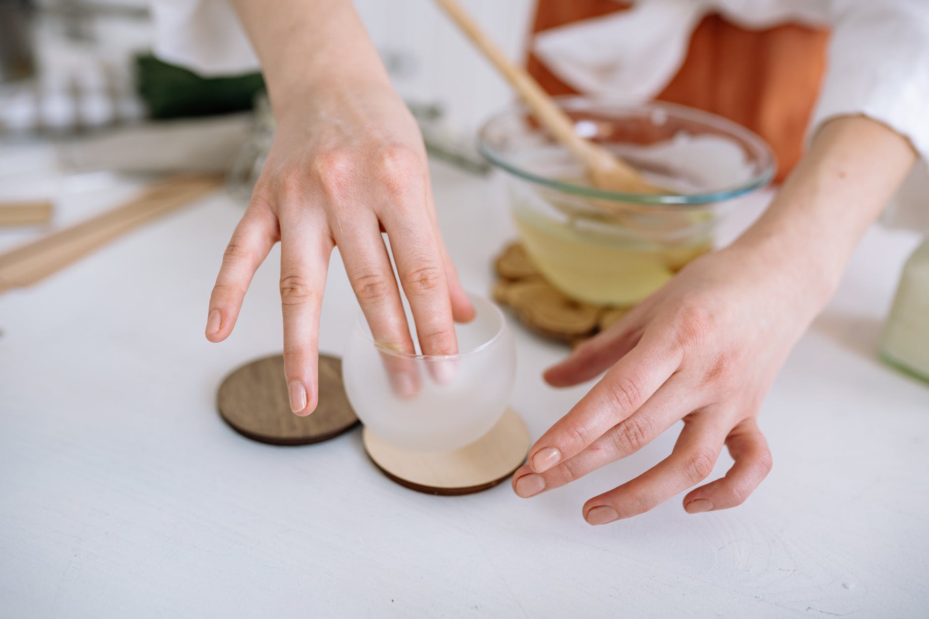 a person preparing a glass container
